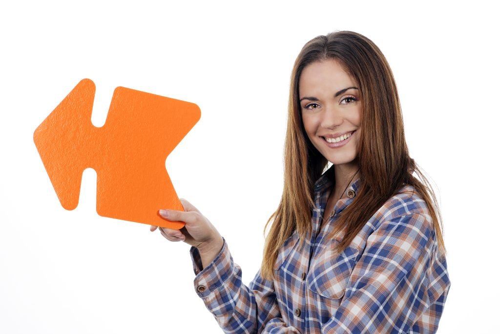 woman holding orange arrow
